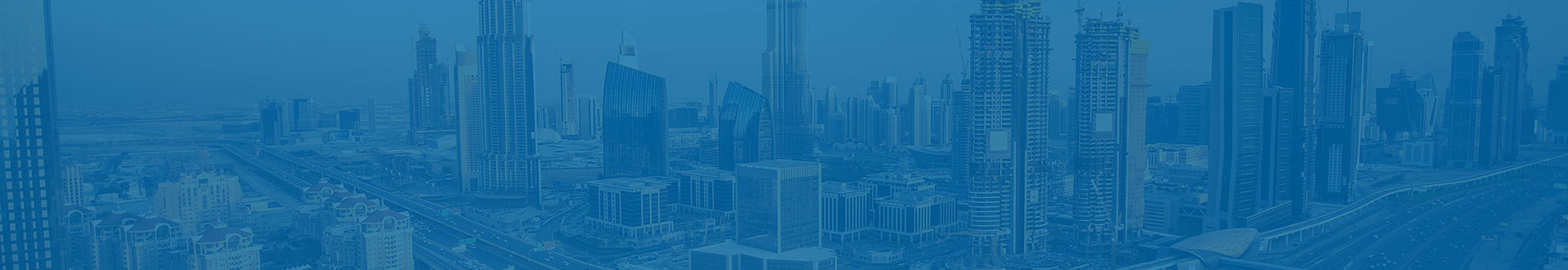 Dubai cityscape with blue overlay. 