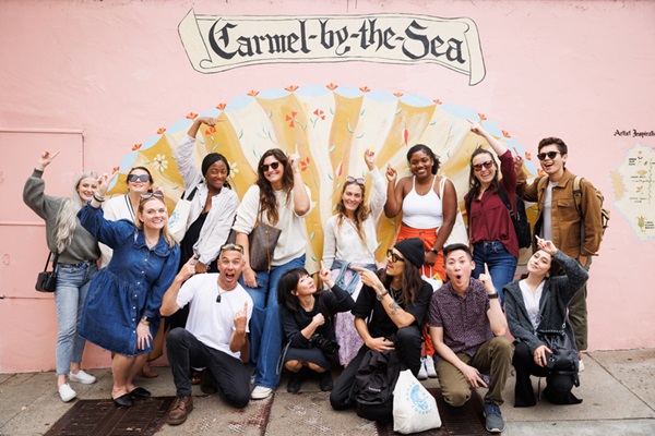 Global Influencer Advisory Board poses in front of seashell mural