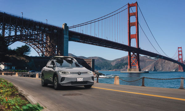two surfers drive their car past the Golden Gate Bridge in San Francisco in Visit California's Born To Be Wild TV spot