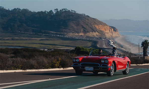 red convertible driving toward Torrey Pines beach in San Diego in Visit California's Born To Be Wild TV spot