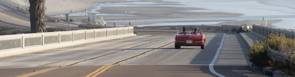 a red convertible approaches Torrey Pines Beach in San Diego in Visit California's Born To Be Wild TV spot
