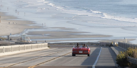 a red convertible approaches Torrey Pines Beach in San Diego in Visit California's Born To Be Wild TV spot