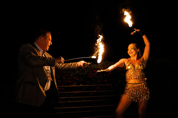 A fire dancer performs at Pismo Beach as part of a familiarization tour for luxury buyers