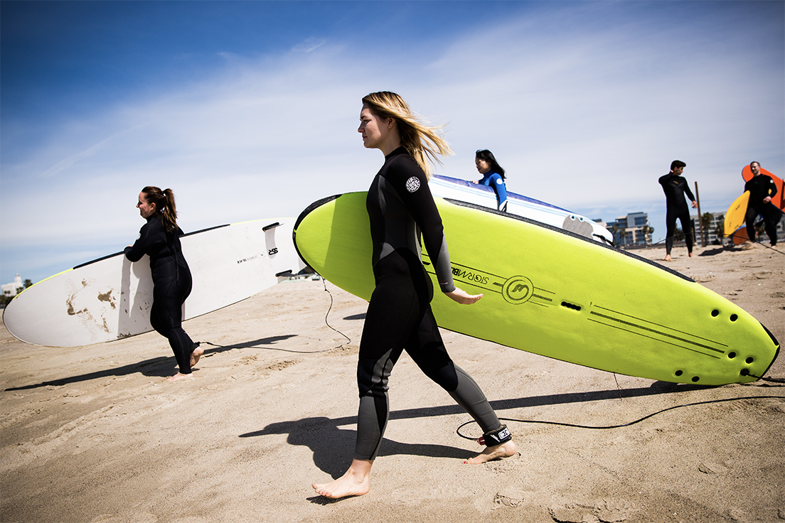 Woman with surfboard LI